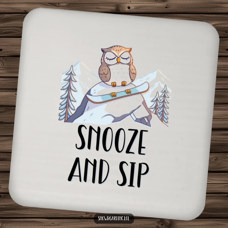 Funny drink coaster featuring a tired owl napping on a snowboard at the mountain peak, adding peaceful charm to surfaces.