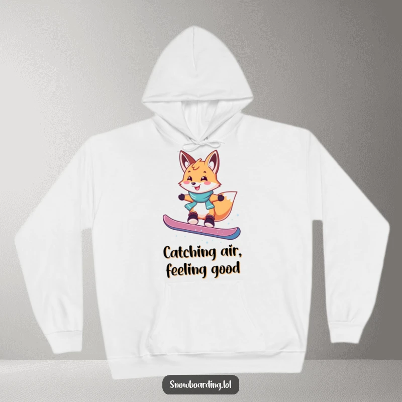 Funny hoodie showcasing a smiling fox performing a playful snowboard jump with a happy, energetic demeanor, embodying winter fun.