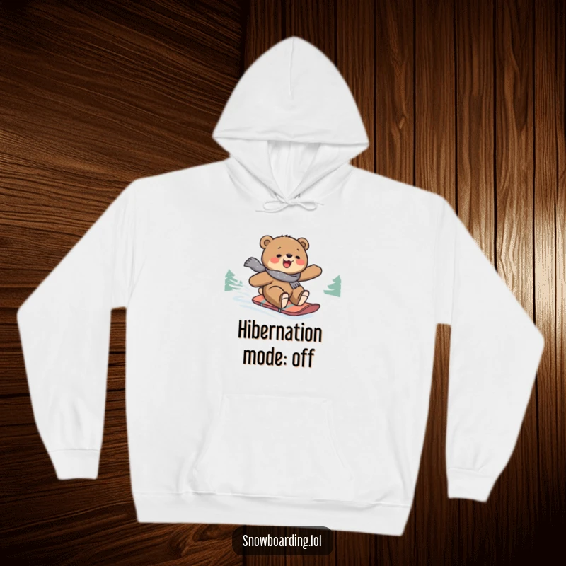 Funny hoodie depicting a gleeful bear confidently snowboarding down a picturesque snowy mountain slope, conveying pure winter joy.