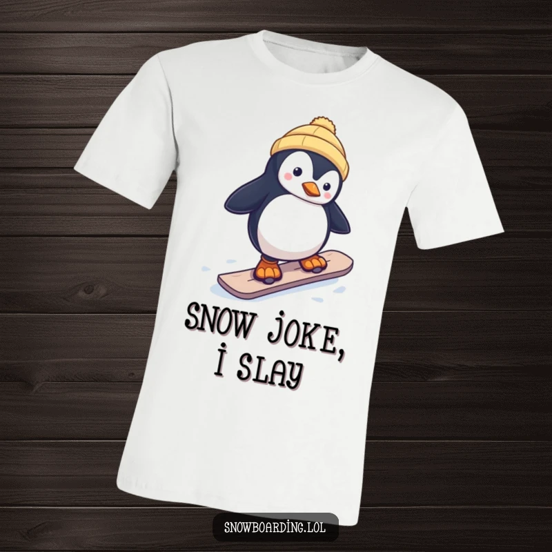 Funny t-shirt with a curious penguin wobbling precariously on a snowboard, conveying cold-weather amusement and playful risk.